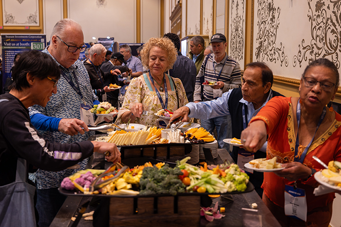 Attendees serve themselves hors d'oeuvres